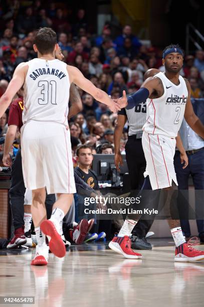 John Wall of the Washington Wizards high-fives Tomas Satoransky of the Washington Wizards during the game against the Cleveland Cavaliers on April 5,...