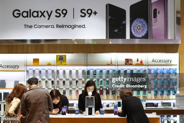 Customers try out Samsung Electronics Co. Galaxy S9 smartphones at the company's D'light flagship store in Seoul, South Korea, on Thursday, April 5,...