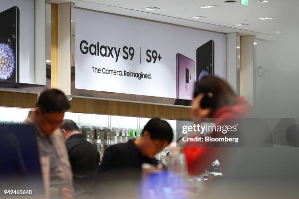 Customers try out Samsung Electronics Co. Galaxy S9 smartphones at the company's D'light flagship store in Seoul, South Korea, on Thursday, April 5,...