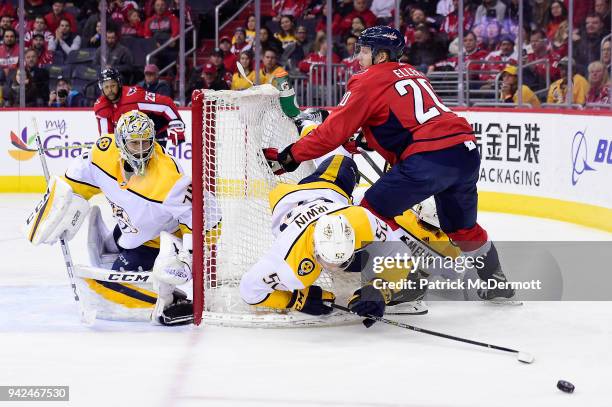 Matt Irwin of the Nashville Predators and Lars Eller of the Washington Capitals collide in the third period at Capital One Arena on April 5, 2018 in...