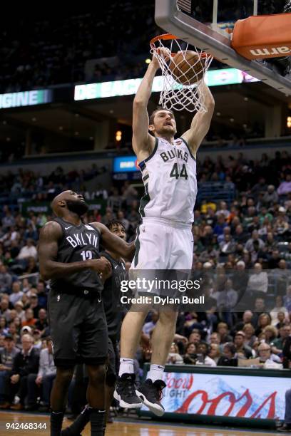 Tyler Zeller of the Milwaukee Bucks dunks the ball past Quincy Acy of the Brooklyn Nets in the fourth quarter at the Bradley Center on April 5, 2018...