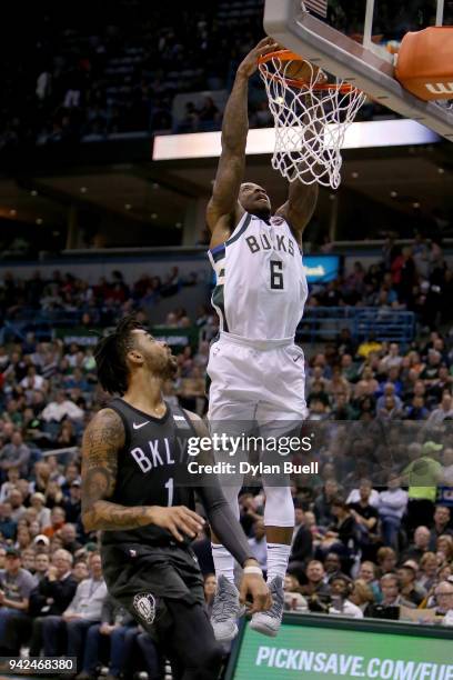 Eric Bledsoe of the Milwaukee Bucks dunks the ball past D'Angelo Russell of the Brooklyn Nets in the third quarter at the Bradley Center on April 5,...