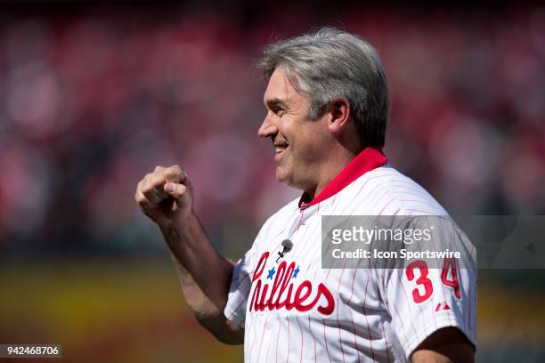 Eagles Head Coach Doug Pederson gestures to the crowd while wearing the jersey of the late Roy Halladay before the game between the Miami Marlins and...