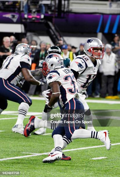 Dion Lewis of the New England Patriots takes the handoff from Tom Brady against the Philadelphia Eagles during Super Bowl LII at U.S. Bank Stadium on...