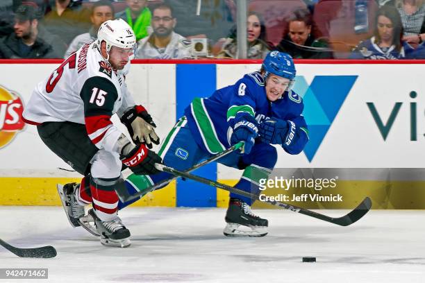Brad Richardson of the Arizona Coyotes checks Christopher Tanev of the Vancouver Canucks during their NHL game at Rogers Arena April 5, 2018 in...