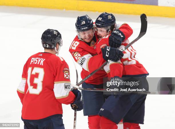 Jared McCann of the Florida Panthers celebrates his game wining goal against the Boston Bruins with Mark Pysyk and Michael Matheson at the BB&T...