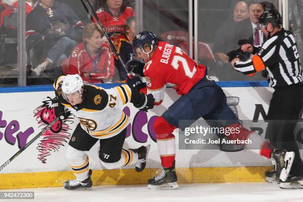 Nick Bjugstad of the Florida Panthers checks Torey Krug of the Boston Bruins during third period action at the BB&T Center on April 5, 2018 in...