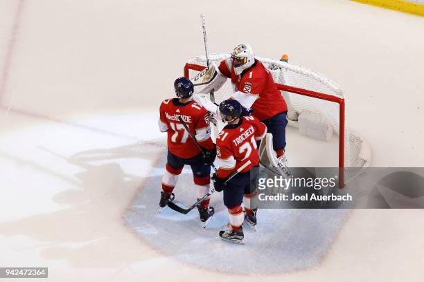 Derek MacKenzie and Vincent Trocheck congratulate Goaltender Roberto Luongo of the Florida Panthers after the game against the Boston Bruins at the...