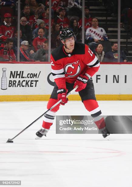 Ben Lovejoy of the New Jersey Devils controls the puck during the game against the New York Rangers at Prudential Center on April 3, 2018 in Newark,...