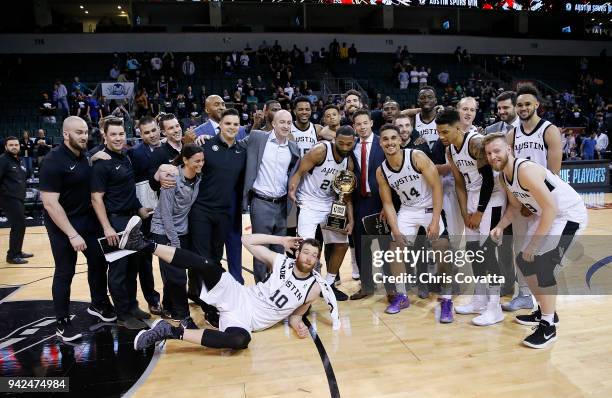 Darrun Hilliard of the Austin Spurs holding the Western Conference Champion trophy with his teammates pose for a portrait after defeating the South...