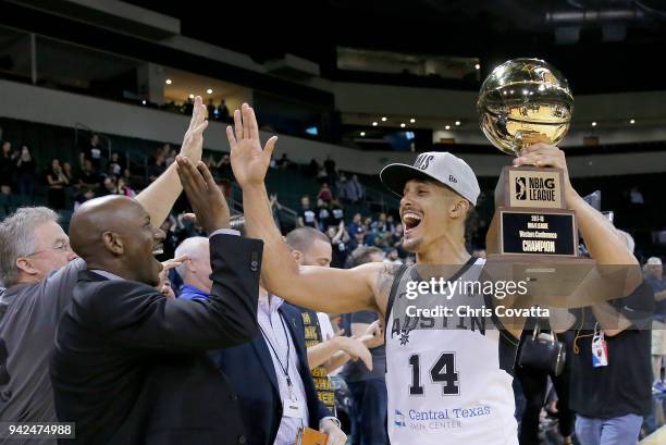 Nick Johnson of the Austin Spurs holding the Western Conference Champion trophy gives high fives after defeating the South Bay Lakers during the...