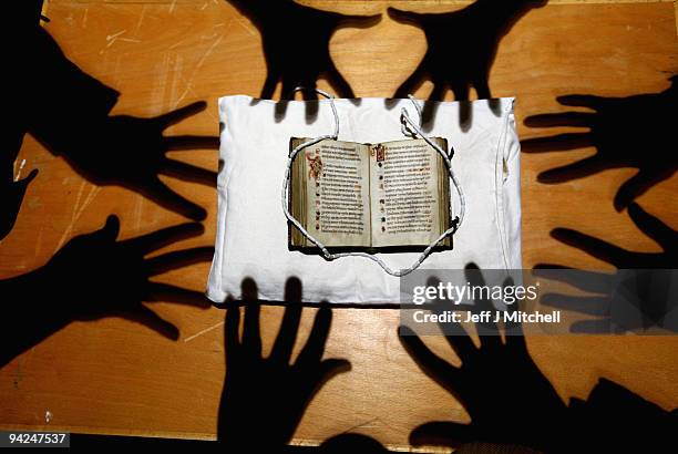 Memebers of staff at the University of Edinburgh view Scotland�s oldest surviving book, a pockets size book of Psalms on December 10, 2009 in...