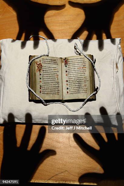 Member of staff at the University of Edinburgh views Scotland�s oldest surviving book, a pockets size book of Psalms on December 10, 2009 in...