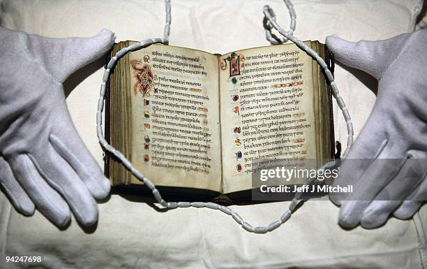 Member of staff at the University of Edinburgh views Scotland�s oldest surviving book, a pockets size book of Psalms on December 10, 2009 in...