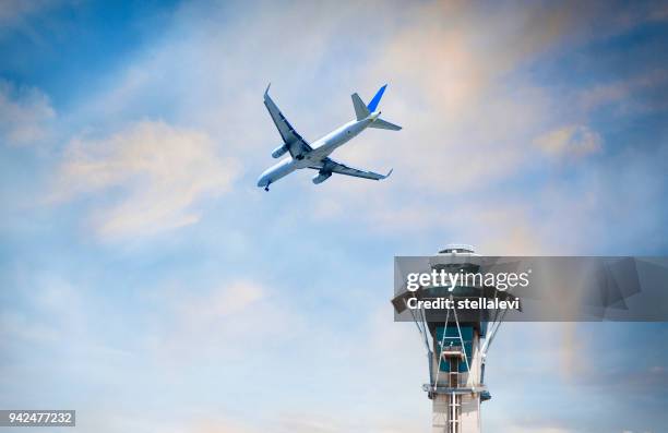flugzeug fliegen über air traffic control tower - air traffic control stock-fotos und bilder