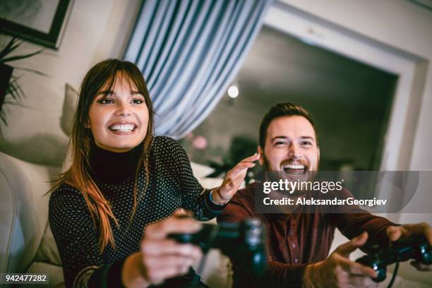 cute teenage couple playing video games on date night - dating game stock pictures, royalty-free photos & images