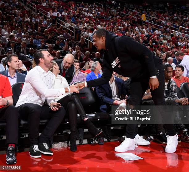 Deshaun Watson and Justin Verlander shake hands during the game between the Houston Rockets and the Portland Trail Blazers on April 5, 2018 at the...