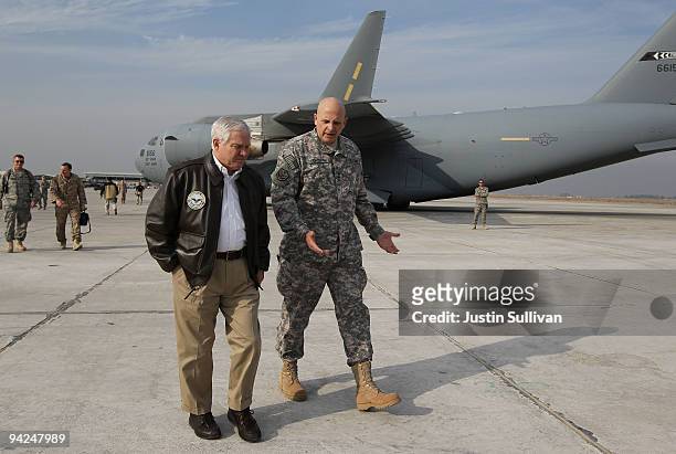 Secretary of Defense Robert Gates walks with U.S. Army Lt. General Kenneth Hunzeker after arriving at Baghdad International Airport December 10, 2009...