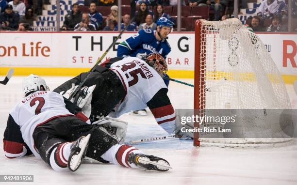 Daniel Sedin of the Vancouver Canucks shoots the puck past a diving goalie Darcy Kuemper of the Arizona Coyotes for a goal in NHL action on April...