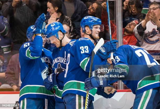 Daniel Sedin of the Vancouver Canucks celebrates his goal with teammates Troy Stecher, Henrik Sedin and Alexander Edler in NHL action against the...