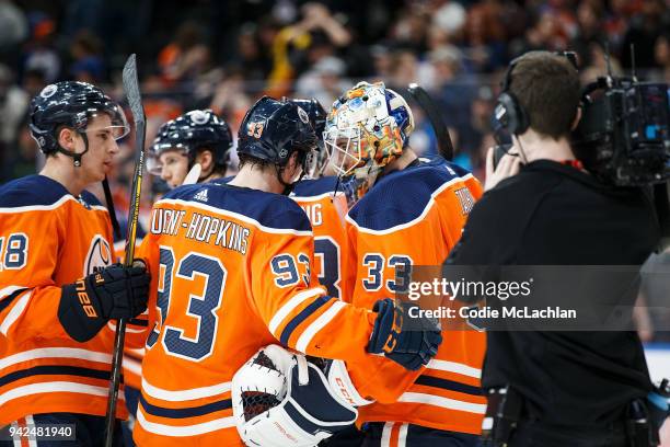 Ryan Nugent-Hopkins and goaltender Cam Talbot of the Edmonton Oilers celebrate their 4 - 3 victory against the Vegas Golden Knights at Rogers Place...