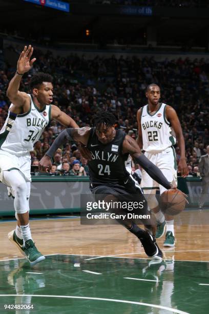 Rondae Hollis-Jefferson of the Brooklyn Nets handles the ball against Giannis Antetokounmpo of the Milwaukee Bucks on April 5, 2018 at the BMO Harris...
