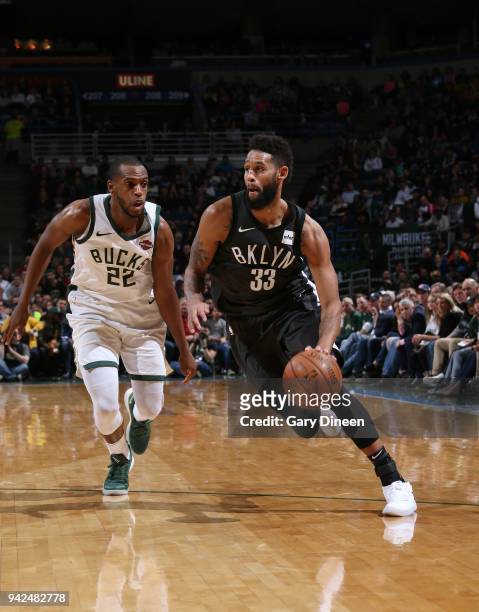 Allen Crabbe of the Brooklyn Nets handles the ball against Khris Middleton of the Milwaukee Bucks on April 5, 2018 at the BMO Harris Bradley Center...