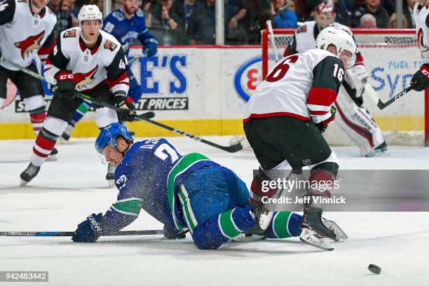 Max Domi of the Arizona Coyotes checks Daniel Sedin of the Vancouver Canucks during their NHL game at Rogers Arena April 5, 2018 in Vancouver,...