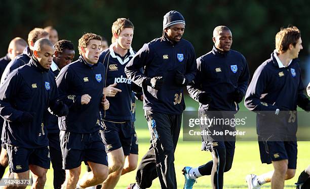 Nwankwo Kanu runs with his team mates during a Portsmouth FC training session at their Eastleigh training ground on December 10, 2009 in Eastleigh,...