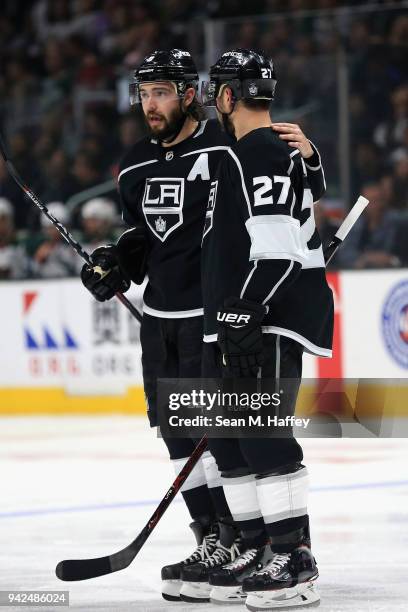 Drew Doughty talks with Alec Martinez of the Los Angeles Kings during the second period of a game against the Minnesota Wild at Staples Center on...