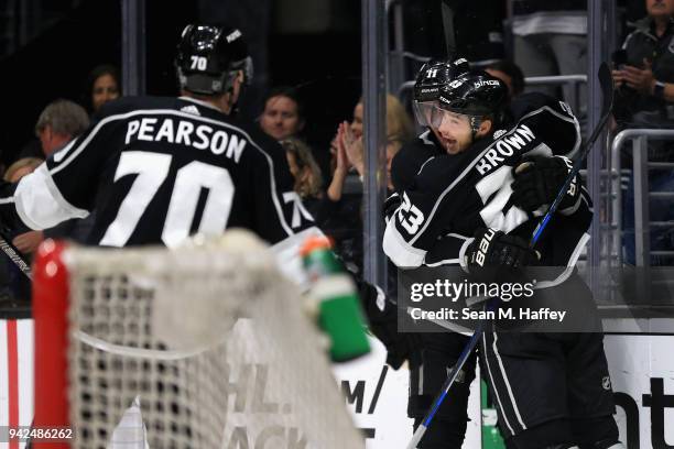 Tanner Pearson and Anze Kopitar congratulate Dustin Brown of the Los Angeles Kings on his goal during the second period of a game against the...