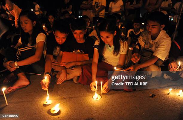 Students listen to speeches during an indignation rally in the town of Koronadal, south Cotabato province on November 25 as investigators in Ampatuan...
