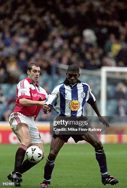 Efan Ekoku of Sheffield Wednesday holds the ball up against Andy Melville of Fulham during the Nationwide League Division One match played at...