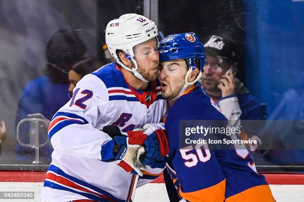 New York Rangers Center Peter Holland and New York Islanders Defenceman Adam Pelech crash into each other during the first period at the Barclays...