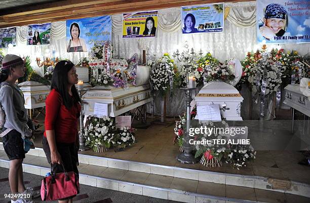 Visitors view the coffins of slain journalists during the wake at a funeral home in General Santos City, South Cotabato on November 30, 2009. A...