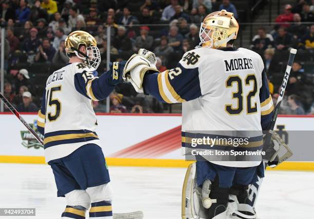 Notre Dame Fighting Irish goaltender Cale Morris congratulates Notre Dame Fighting Irish center Andrew Oglevie on his 2nd period goal during a Frozen...