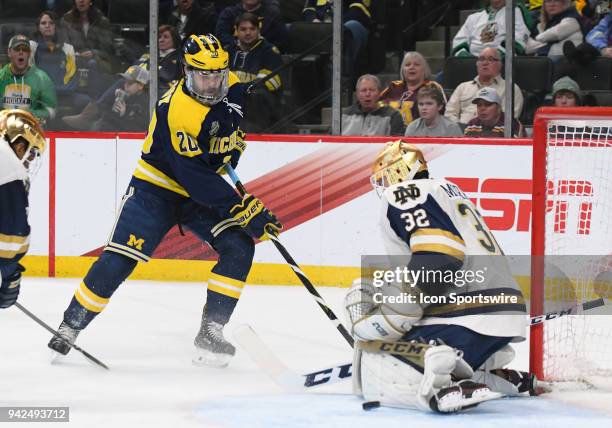 Michigan Wolverines forward Cooper Marody is stopped by Notre Dame Fighting Irish goaltender Cale Morris during a Frozen Four Semifinal between the...