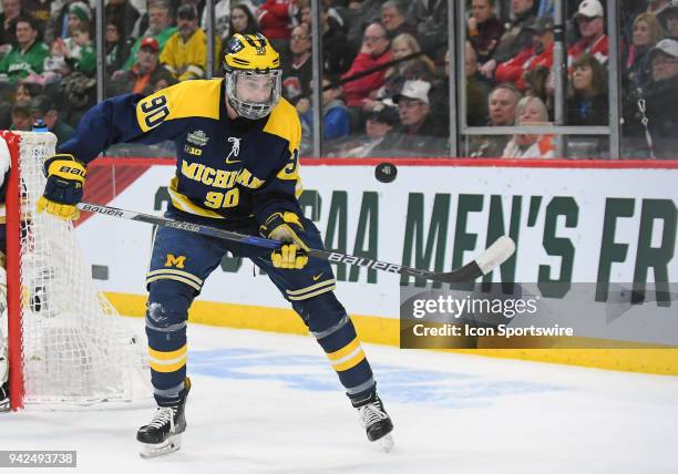 Michigan Wolverines forward Dexter Dancs bats down a flying puck during a Frozen Four Semifinal between the University of Michigan and Notre Dame on...
