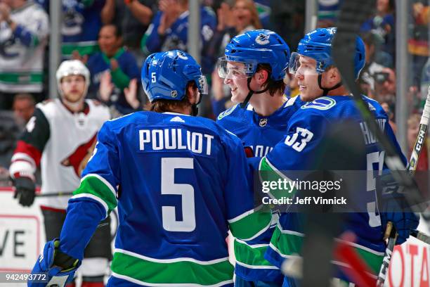 Jake Virtanen of the Vancouver Canucks celebrates with teammates Bo Horvat and Derrick Pouliot after a Vancouver goal during their NHL game against...