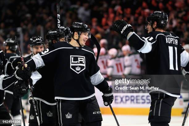 Dustin Brown is congratulated by Anze Kopitar of the Los Angeles Kings after scoring the winning goal in overtime, his fourth of the game against the...