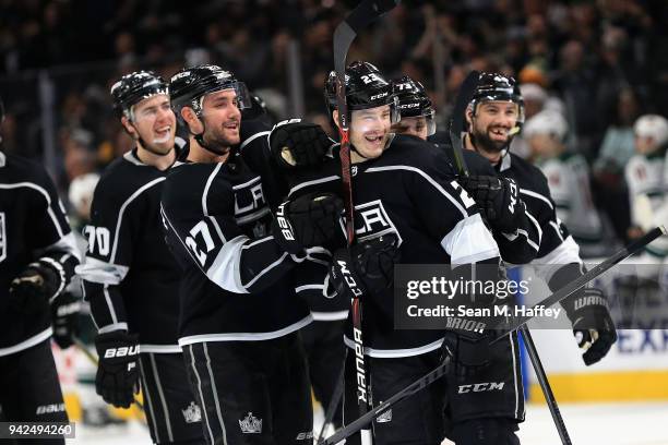 Dustin Brown is congratulated by Tanner Pearson and Alec Martinez of the Los Angeles Kings after scoring the winning goal in overtime, his fourth of...