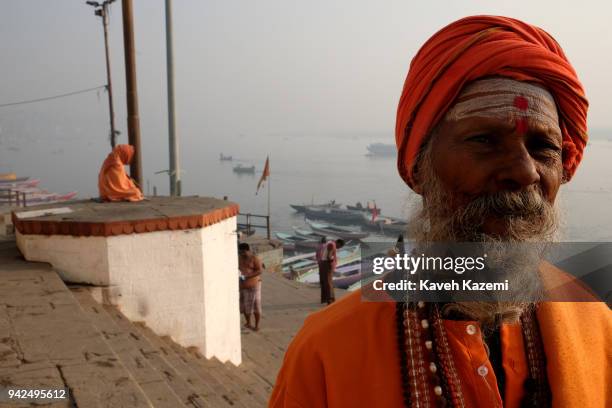 Sadhu seen standing in front of a sage meditating while sat on a high ground in Vijayanagaram Ghat facing the Ganga River on January 28, 2018 in...