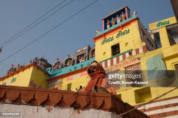 Sage man meditates while sat on a high ground in Vijayanagaram Ghat facing the Ganga River on January 28, 2018 in Varanasi, India. Vijayanagaram Ghat...