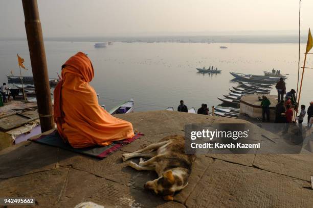 Sage man meditates while sat on a high ground in Vijayanagaram Ghat facing the Ganga River on January 28, 2018 in Varanasi, India. Varanasi is a...