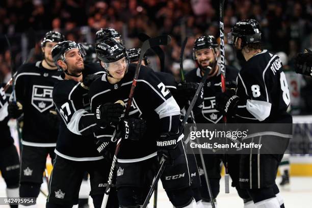 Dustin Brown is congratulated by Drew Doughty and Alec Martinez of the Los Angeles Kings after scoring the winning goal in overtime, his fourth of...