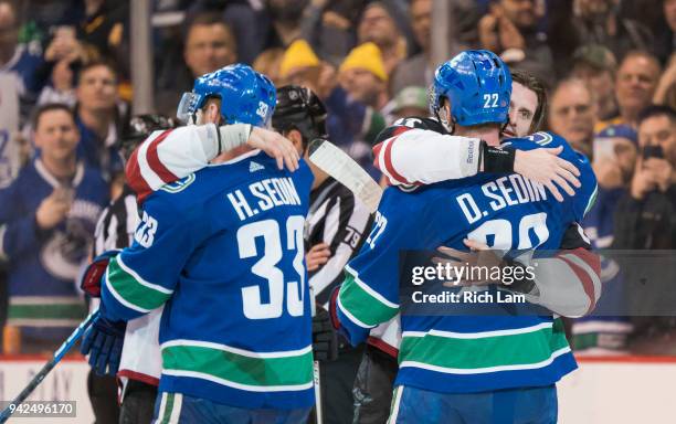 Brad Richardson and Oliver Ekman-Larsson of the Arizona Coyotes embrace Henrik Sedin and Daniel Sedin of the Vancouver Canucks after their NHL game...