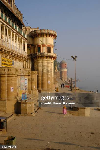 Woman stands in front of Ganga Mahal Ghat on the banks of Ganga River on January 29, 2018 in Varanasi, India. Varanasi is a major religious hub in...