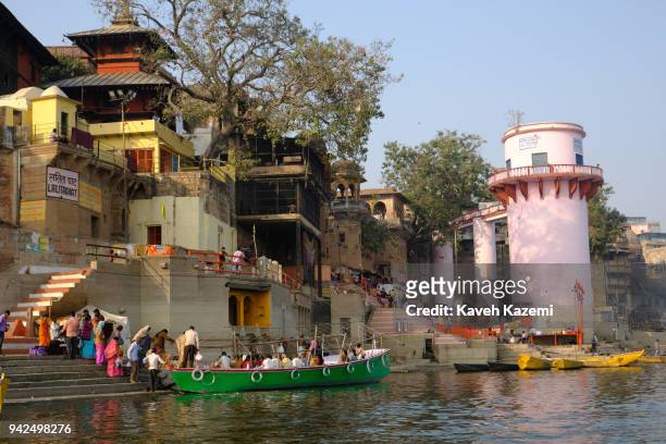 Old temples are seen behind Lalita Ghat on the banks of Ganga River where visitors enjoy a late afternoon boat ride on January 29, 2018 in Varanasi,...