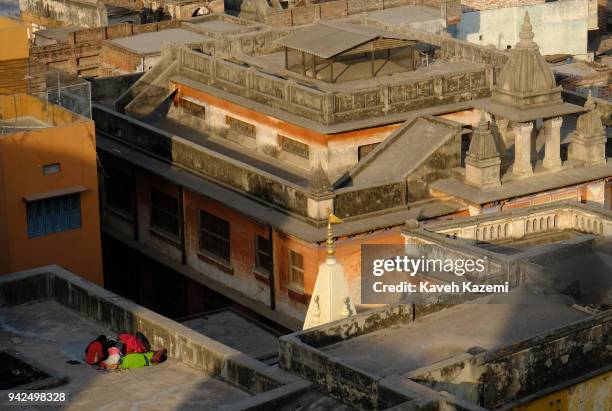 People seen on their rooftop surrounded by temples on January 30, 2018 in Varanasi, India. Varanasi is a major religious hub in India, it is the...