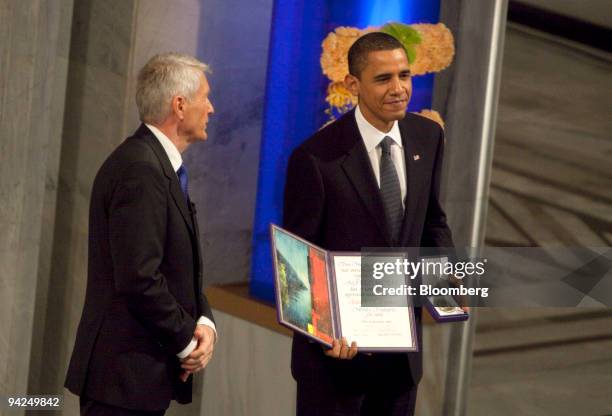 President Barack Obama, right, receives the Nobel Peace Prize from Thorbjoern Jagland, chairman of the Nobel committee, during a ceremony in Oslo,...